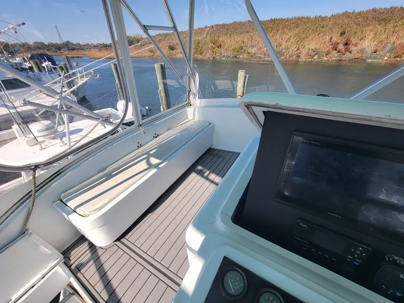 Slide: The Image of 1998 Custom Carolina 45 Willis Boatworks cockpit with seating and navigation equipment. - 14