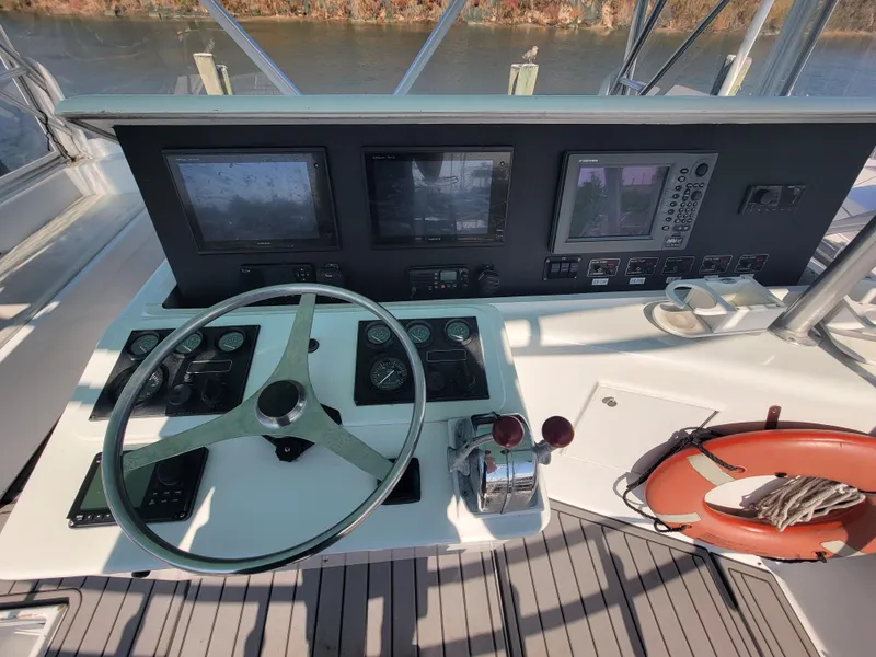 Slide: The Image of Helm of 1998 Custom Carolina 45 Willis Boatworks with navigation instruments and steering wheel. - 15