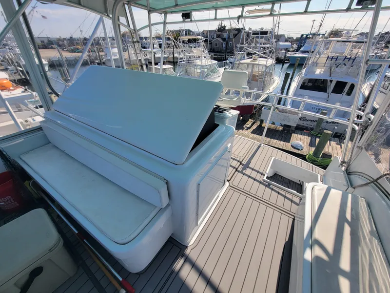 Slide: The Image of 1998 Custom Carolina 45 Willis Boatworks deck with seating, docked at marina. - 16