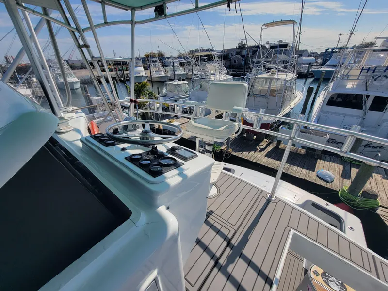 Slide: The Image of Helm of 1998 Custom Carolina 45 Willis Boatworks, docked with other boats in marina. - 17