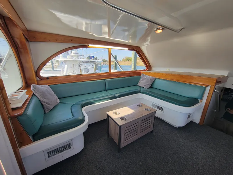 Slide: The Image of Luxurious interior of 1998 Custom Carolina 45 Willis Boatworks with teal seating and wooden accents. - 21