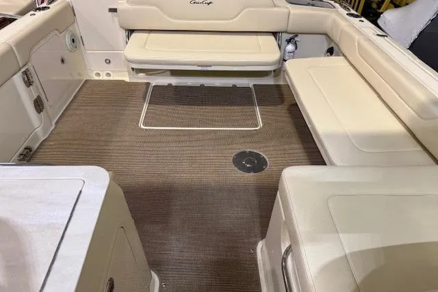 Slide: The Image of 2023 Chris-Craft Calypso 28 boat interior with beige seating and brown flooring. - 17