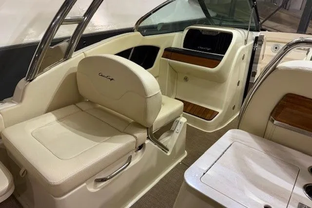 Slide: The Image of 2023 Chris-Craft Calypso 28 interior with beige seating and wood accents. - 19