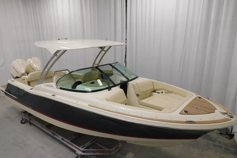 Slide: The Image of 2023 Chris-Craft Calypso 28 boat in a storage facility, showcasing sleek design and craftsmanship. - 2