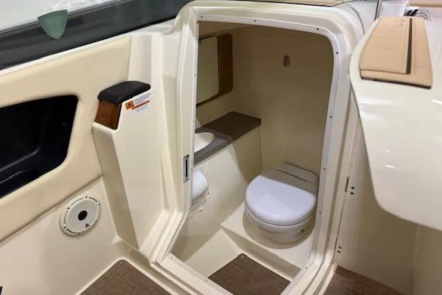 Slide: The Image of 2023 Chris-Craft Calypso 28 boat interior with compact bathroom and toilet. - 20