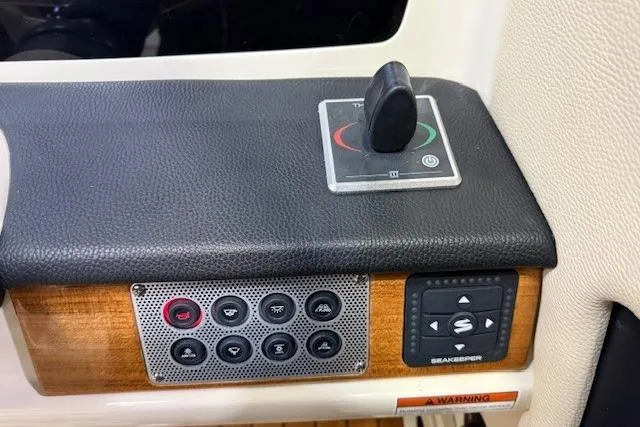 Slide: The Image of Control panel of 2023 Chris-Craft Calypso 28 boat with joystick and buttons. - 24