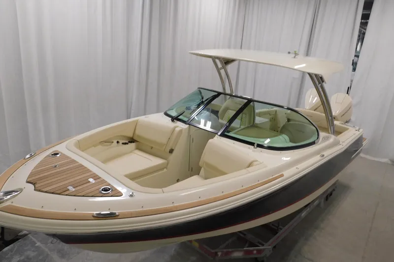 Slide: The Image of 2023 Chris-Craft Calypso 28 boat docked with blue cover and twin engines. - 3