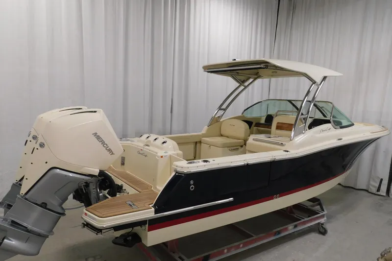 Slide: The Image of 2023 Chris-Craft Calypso 28 boat with dual Mercury engines in a showroom. - 5
