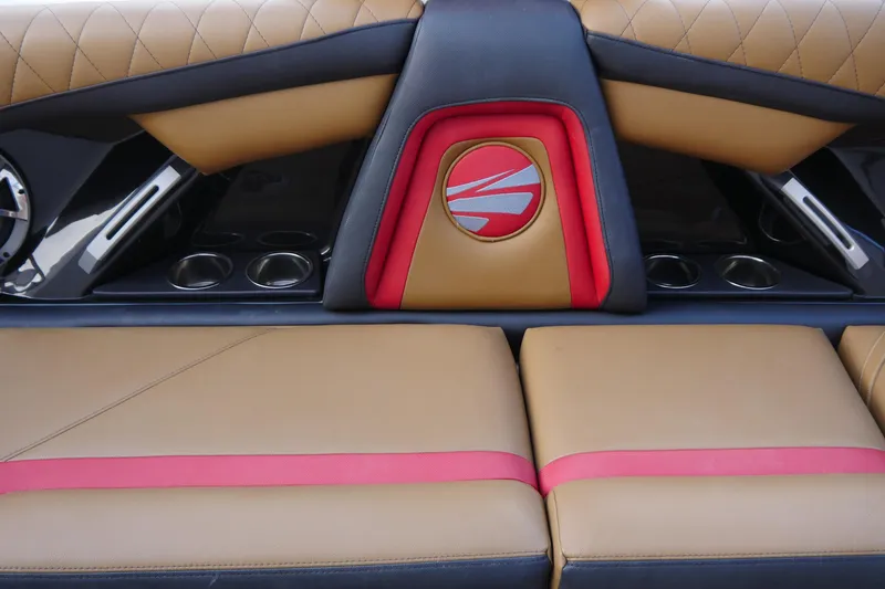 Slide: The Image of 2017 Tigé RZX2 boat interior with tan and red upholstery, featuring cup holders and stylish design. - 12