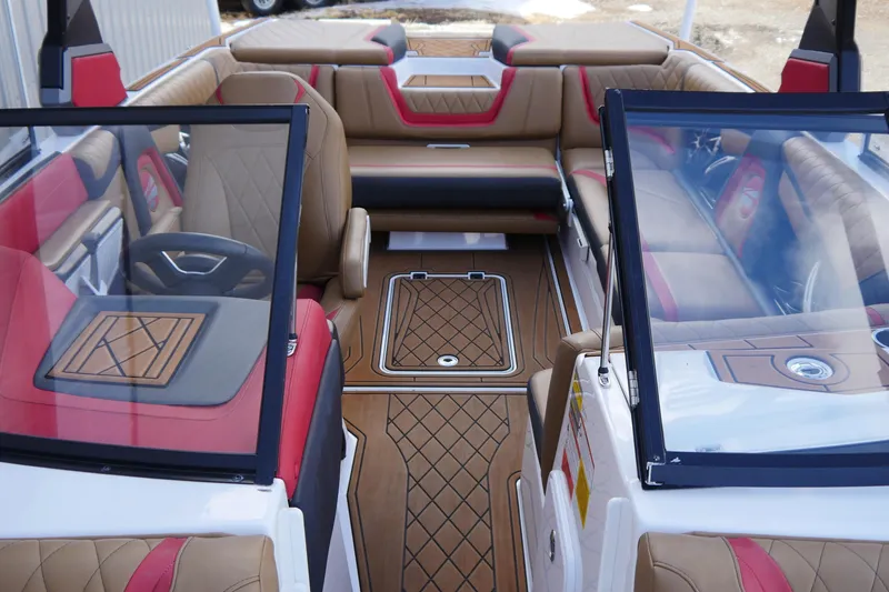 Slide: The Image of 2017 Tigé RZX2 boat interior with luxurious tan and red seating, sleek design. - 14