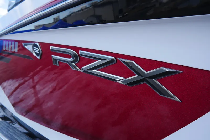Slide: The Image of 2017 Tigé RZX2 boat with red and white exterior detailing. - 6