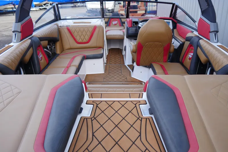 Slide: The Image of 2017 Tigé RZX2 boat interior with luxurious tan and red seating, stylish design. - 8