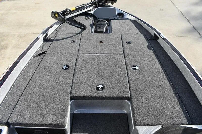 Slide: The Image of 2026 Triton 179 TrX boat deck with carpeted surface and storage compartments. - 13