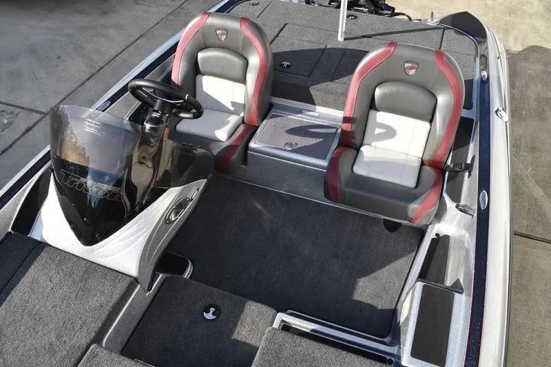 Slide: The Image of 2026 Triton 179 TrX boat interior with dual seats and steering console. - 16