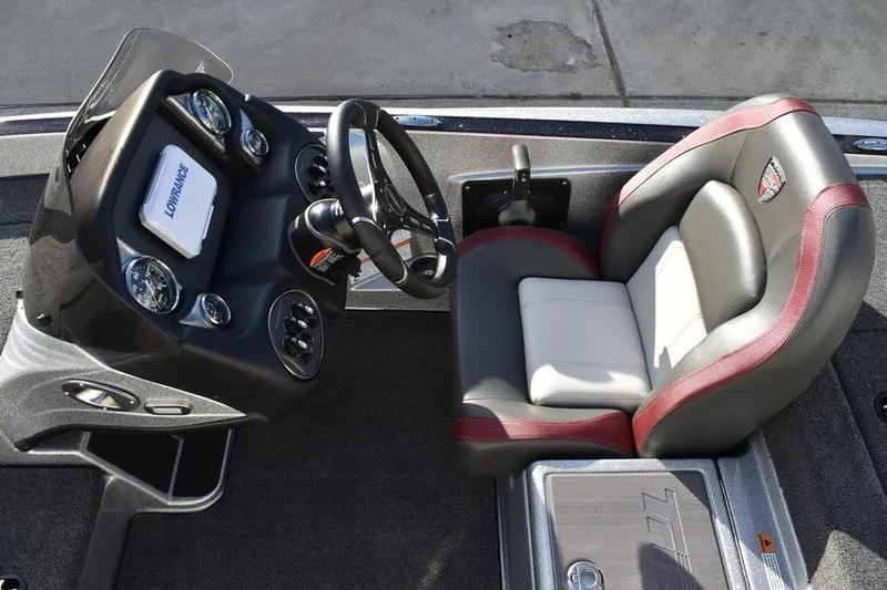 Slide: The Image of 2026 Triton 179 TrX boat cockpit with steering wheel and cushioned seat. - 19