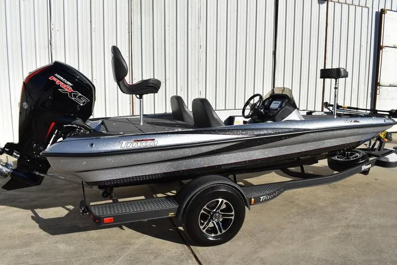 Slide: The Image of 2026 Triton 179 TrX bass boat with Mercury Pro XS engine, parked on trailer. - 2
