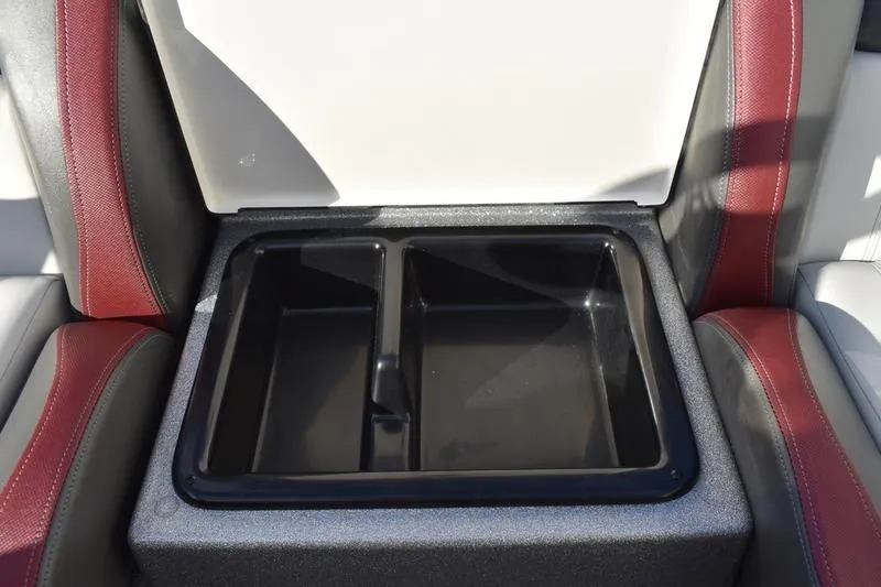 Slide: The Image of 2026 Triton 179 TrX boat seat storage compartment with dual sections, red and gray upholstery. - 22