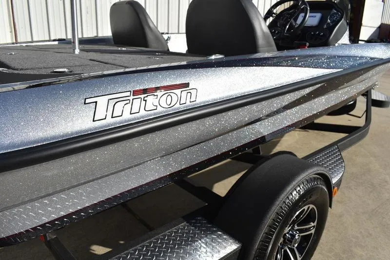 Slide: The Image of 2026 Triton 179 TrX boat with sleek design and metallic finish. - 23