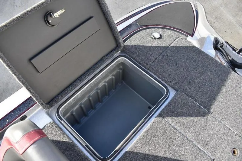 Slide: The Image of Open storage compartment on 2026 Triton 179 TrX boat deck. - 26