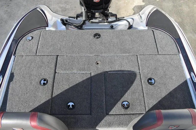 Slide: The Image of 2026 Triton 179 TrX boat deck with carpeted storage compartments and motor. - 29