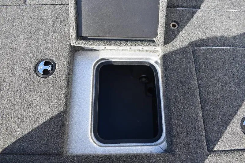 Slide: The Image of 2026 Triton 179 TrX boat storage compartment with open lid, showcasing interior space. - 32