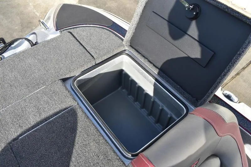 Slide: The Image of Open storage compartment in 2026 Triton 179 TrX boat, featuring carpeted interior. - 36