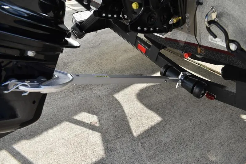 Slide: The Image of 2026 Triton 179 TrX boat trailer with motor support on concrete surface. - 39