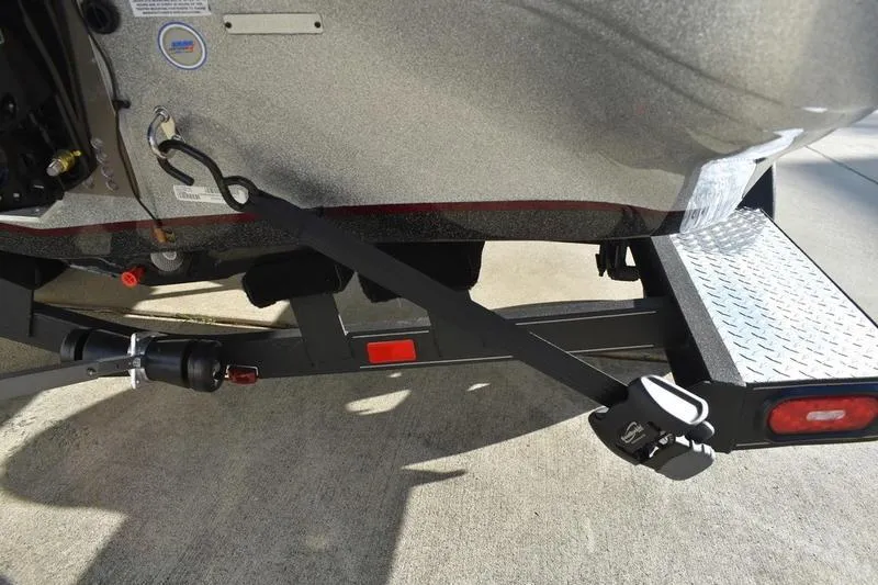 Slide: The Image of 2026 Triton 179 TrX boat trailer hitch and rear detail on concrete surface. - 40