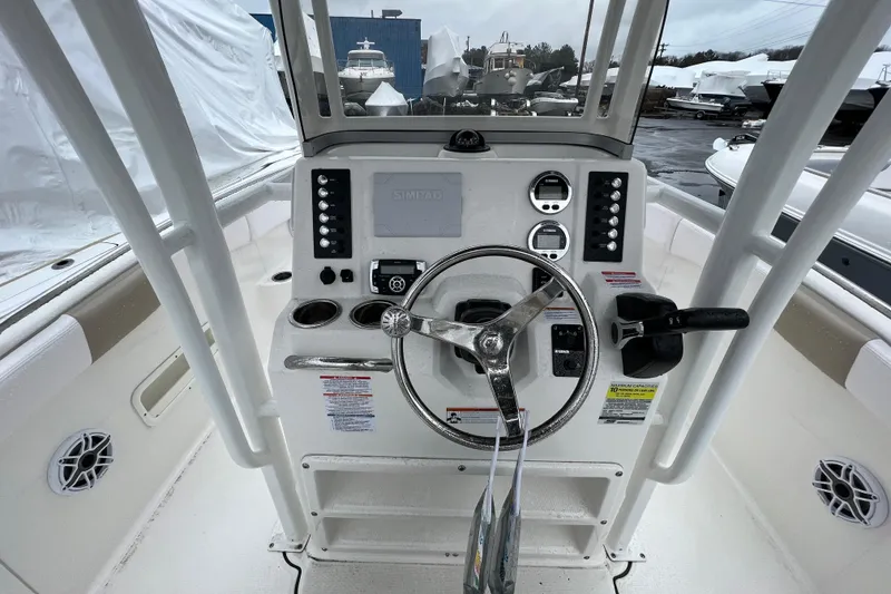 Slide: The Image of 2021 Robalo R222 Center Console boat dashboard with steering wheel and controls. - 5