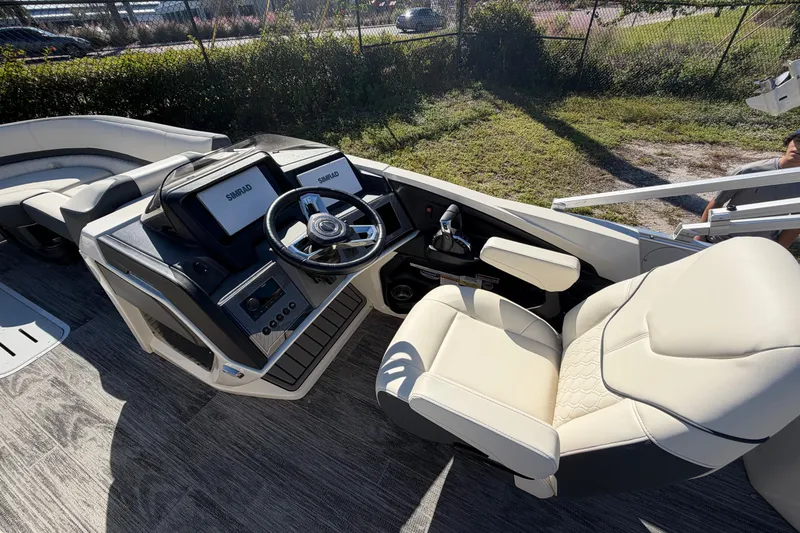 Slide: The Image of 2026 Avalon Catalina boat helm with steering wheel and comfortable captain's chair. - 1