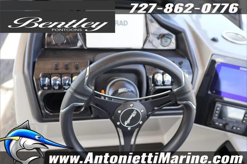 Slide: The Image of Steering wheel of 2026 Bentley Pontoons Elite 253 Admiral, featuring control panel and branding. - 12