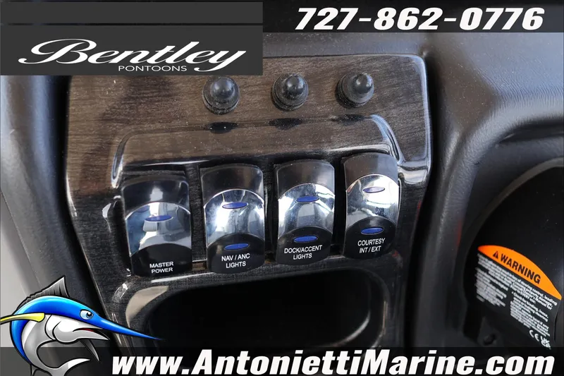 Slide: The Image of Control panel of 2026 Bentley Pontoons Elite 253 Admiral with various switches. - 13