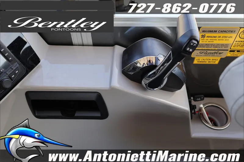 Slide: The Image of Control panel of 2026 Bentley Pontoons Elite 253 Admiral with throttle and capacity details. - 17