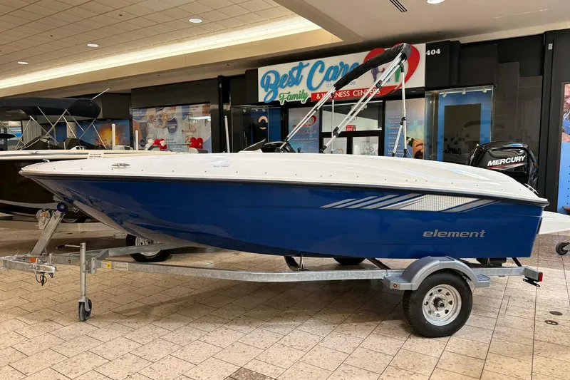 The Image of 2025 Bayliner Element E16 boat displayed indoors on a trailer. - 0