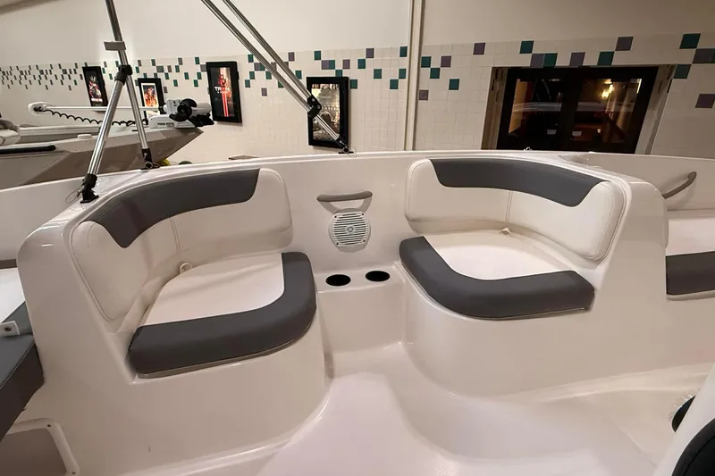 Slide: The Image of 2025 Bayliner Element E16 boat interior with gray and white seating. - 3