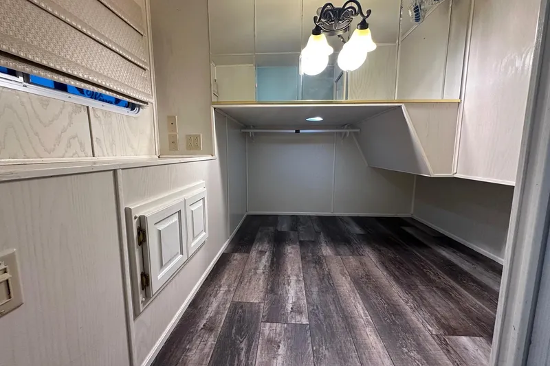 Slide: The Image of Small room with wood flooring, white walls, and overhead lighting in a 2000 Sharpe 16x90 model. - 10