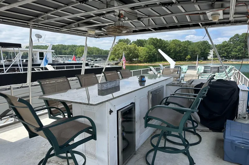 Slide: The Image of Outdoor seating area on a 2000 Sharpe 16x90 houseboat with bar and chairs. - 17