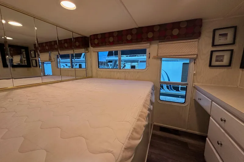 Slide: The Image of Bedroom interior of 2000 Sharpe 16x90 houseboat with mirrored walls and large bed. - 7