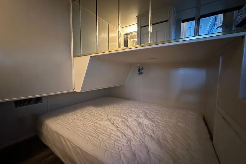 Slide: The Image of Compact bedroom with mirrored cabinets in a 2000 Sharpe 16x90 model. - 8