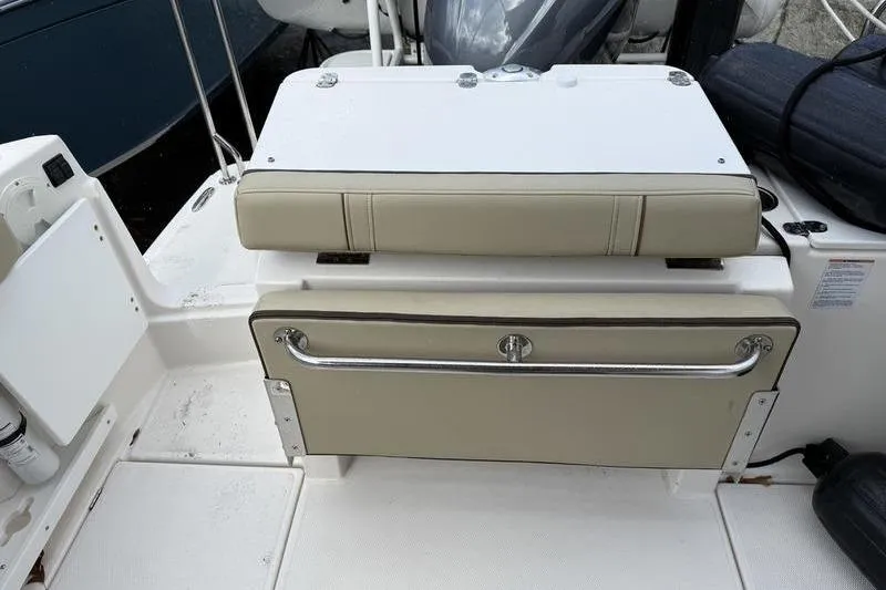 Slide: The Image of 2021 Ranger Tugs R-27 boat seating area with storage compartment. - 10