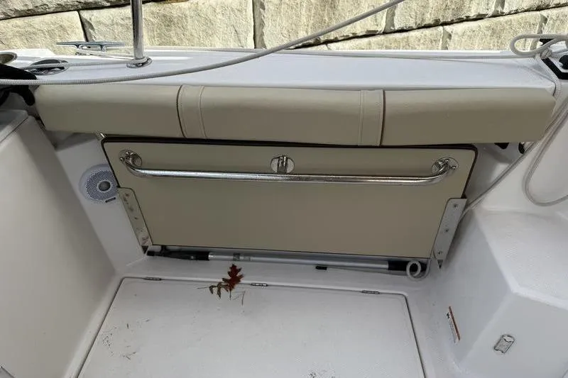 Slide: The Image of 2021 Ranger Tugs R-27 boat interior with foldable seat and clean deck. - 11