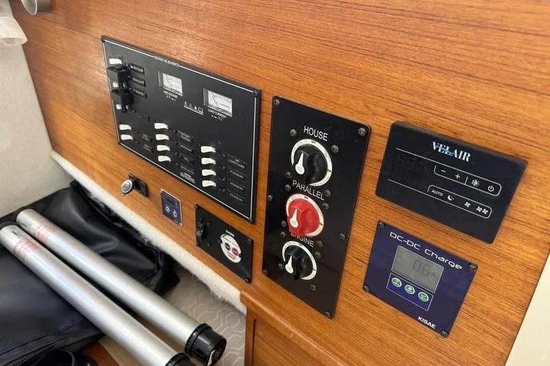 Slide: The Image of Control panel of a 2021 Ranger Tugs R-27 boat with various switches and displays. - 15