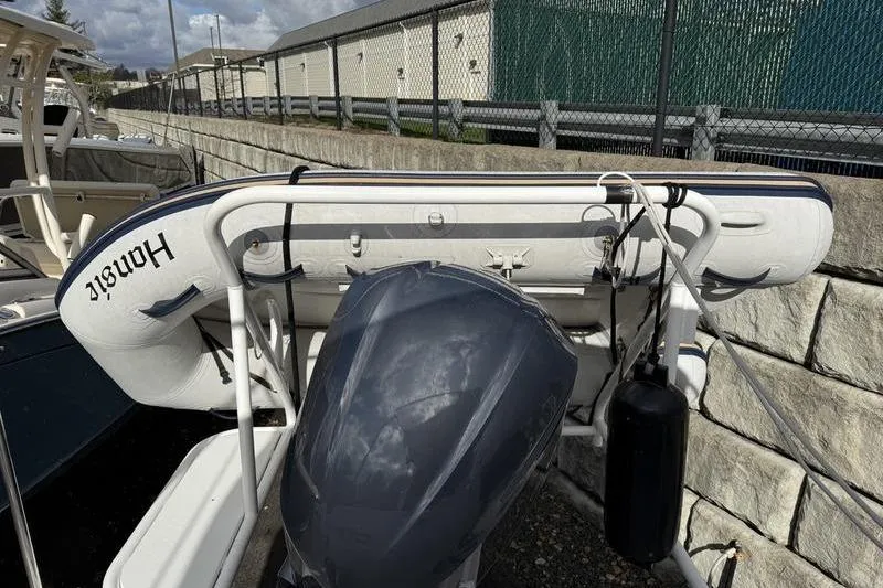 Slide: The Image of 2021 Ranger Tugs R-27 with outboard motor and inflatable boat on deck. - 16