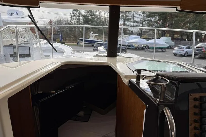 Slide: The Image of Interior view of 2021 Ranger Tugs R-27 boat cockpit with marina background. - 22