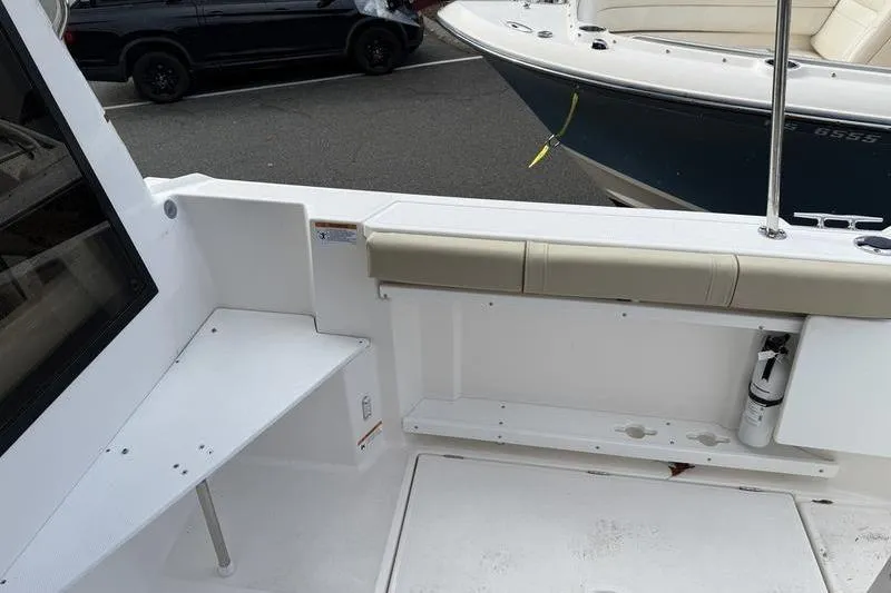 Slide: The Image of 2021 Ranger Tugs R-27 boat deck with seating and storage area. - 5