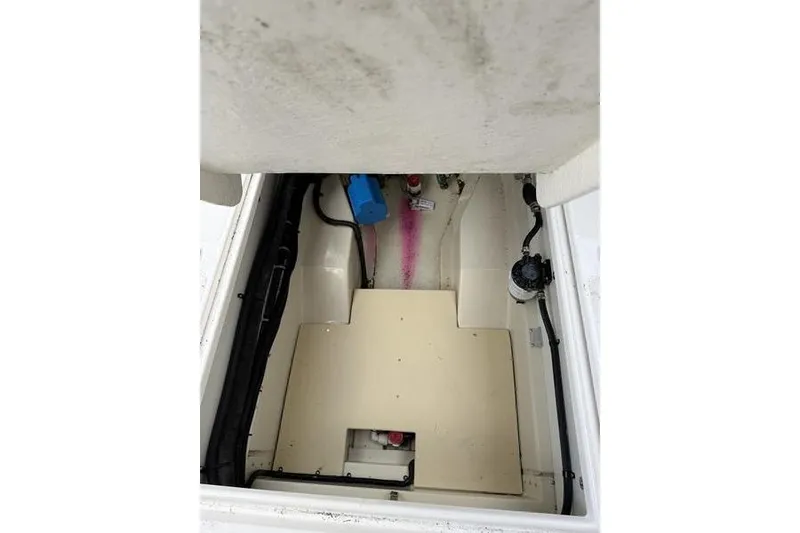 Slide: The Image of 2021 Ranger Tugs R-27 engine compartment with visible wiring and components. - 6