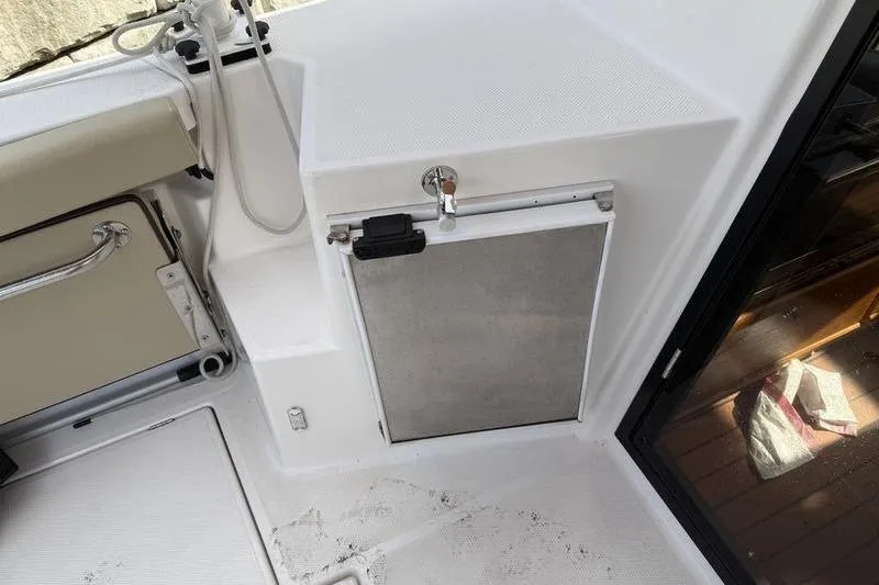 Slide: The Image of 2021 Ranger Tugs R-27 boat interior with storage compartment and seating area. - 7