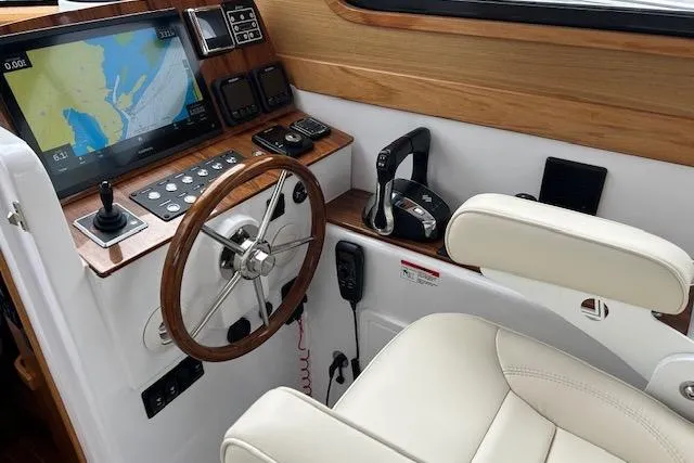 Slide: The Image of 2024 True North 34 Outboard Express helm with navigation screen and controls. - 12