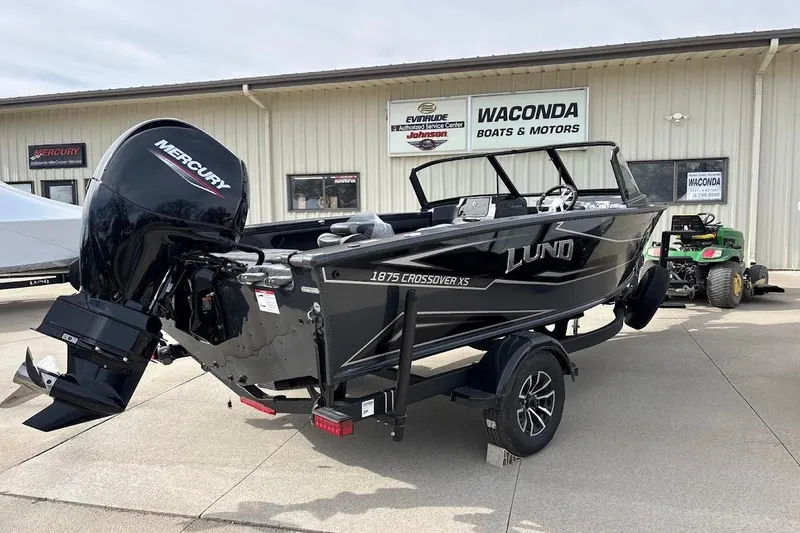 Slide: The Image of 2026 Lund 1875 Crossover XS boat with Mercury engine at dealership. - 6