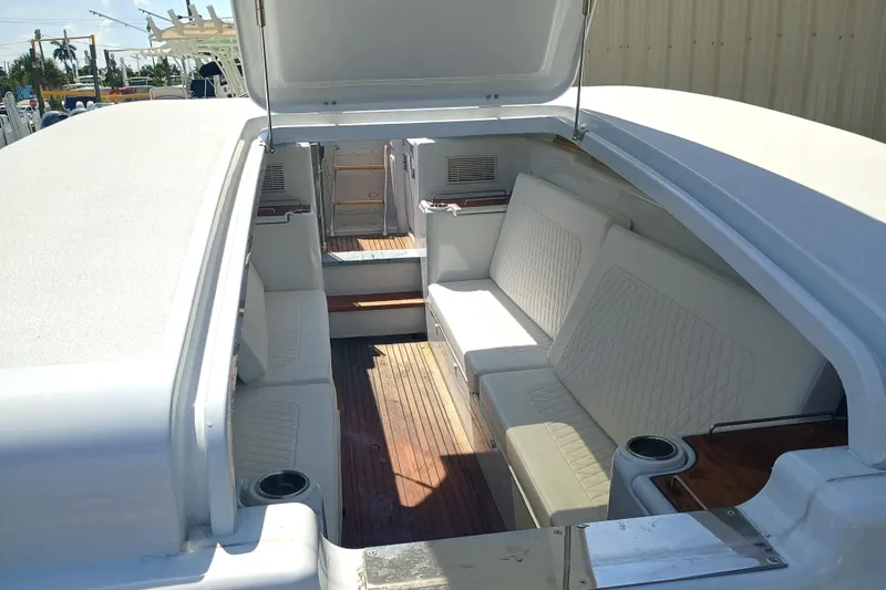 Slide: The Image of Interior of a 2006 Royal Denship Royal Limo yacht with white seating and wooden flooring. - 11